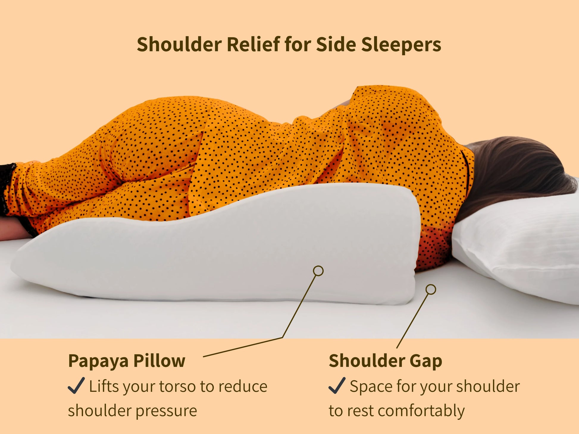 Side sleeper using the Papaya Pillow with a visible gap relieving pressure on the shoulder and aligning the spine.